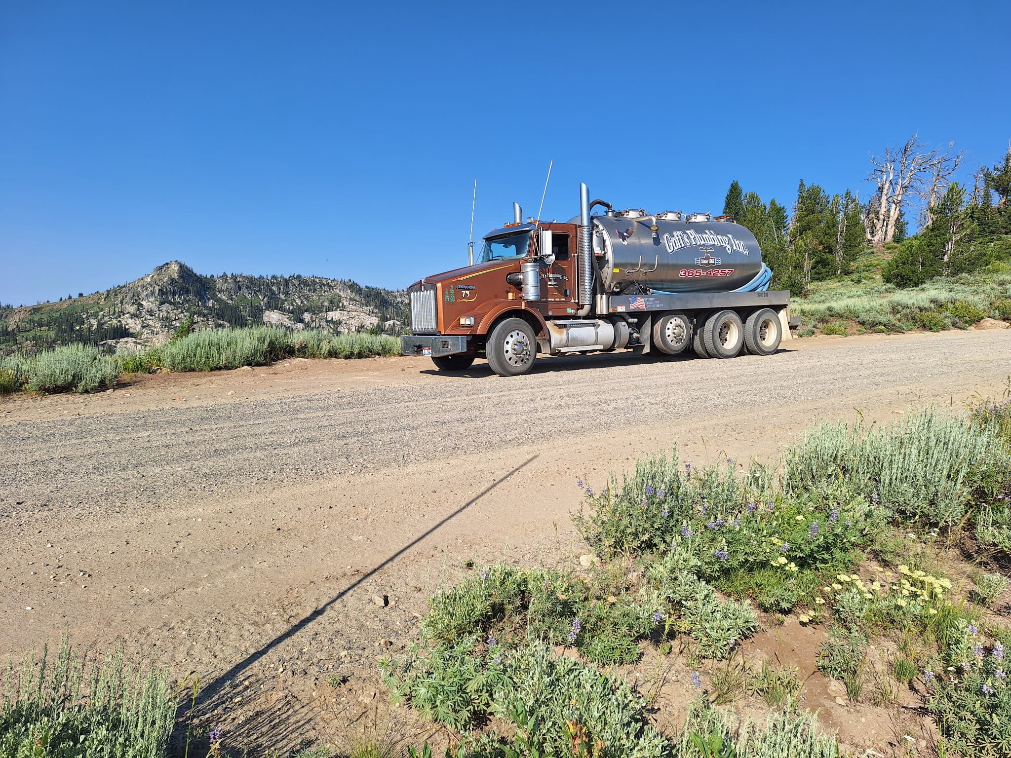 Goff's Plumbing, Inc. septic pumper truck on a rural Idaho road