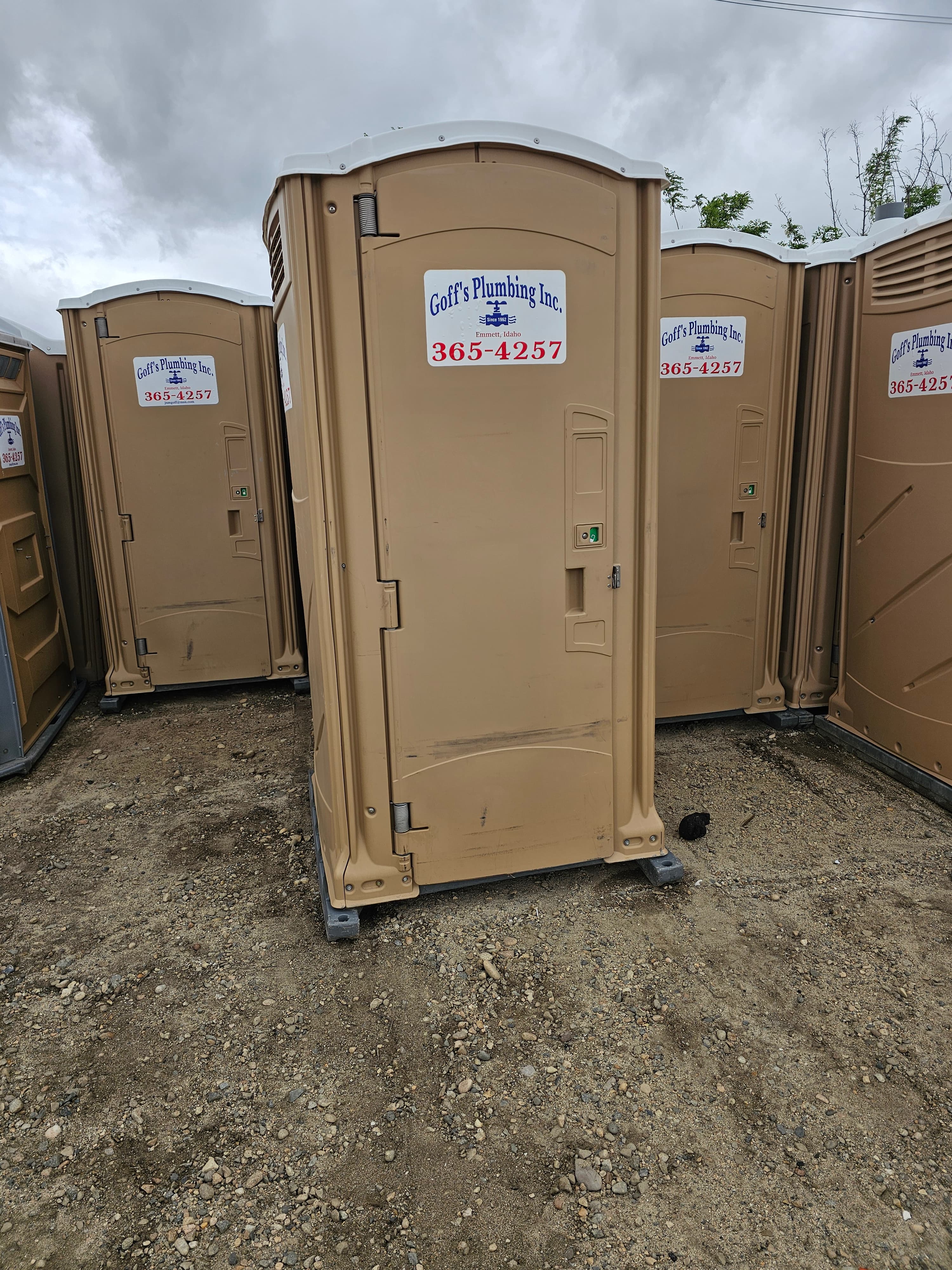Tan standard portable toilet rental unit from Goff's Plumbing, Inc.